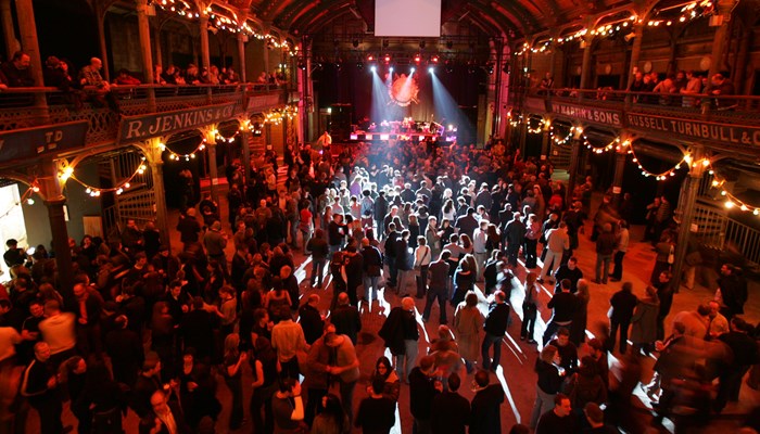 Large crowd at Old Fruitmarket music venue with atmospheric lighting