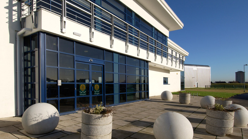 Entrance of Glasgow Museums Resource Centre. The entrance is mostly glass windows. 