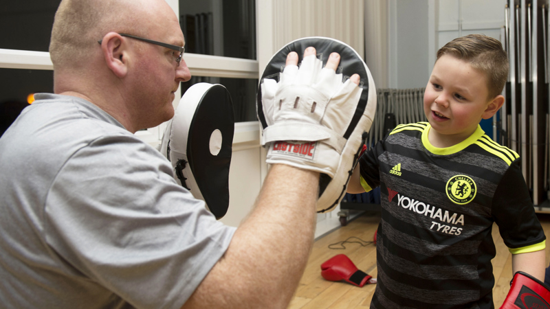 Man and boy with boxing gloves