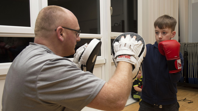 Man and boy with boxing gloves