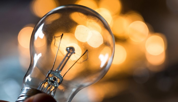 A bulb pictured in front of glowing lights