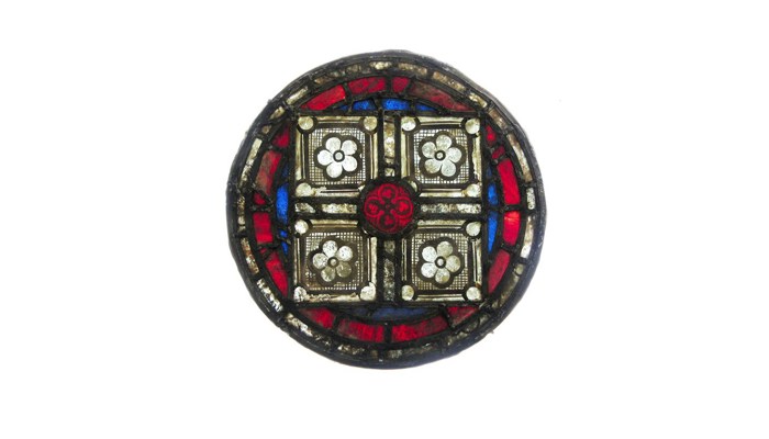 a stained glass roundel with various patterns inside