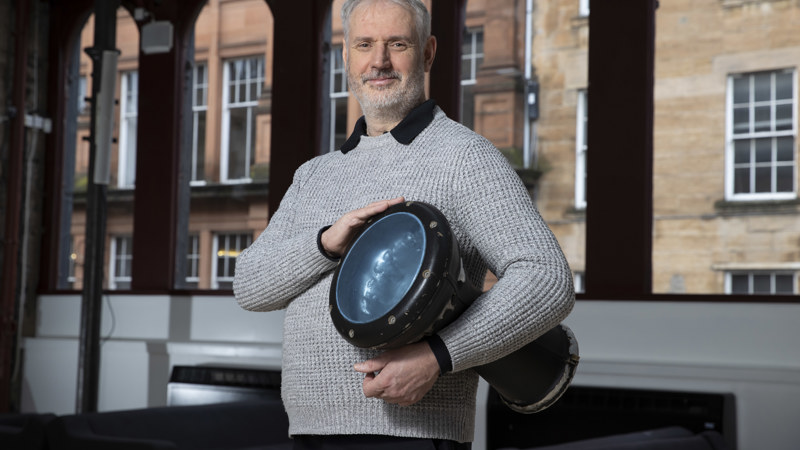 Conductor Paul MacAlindin poses with a drum 