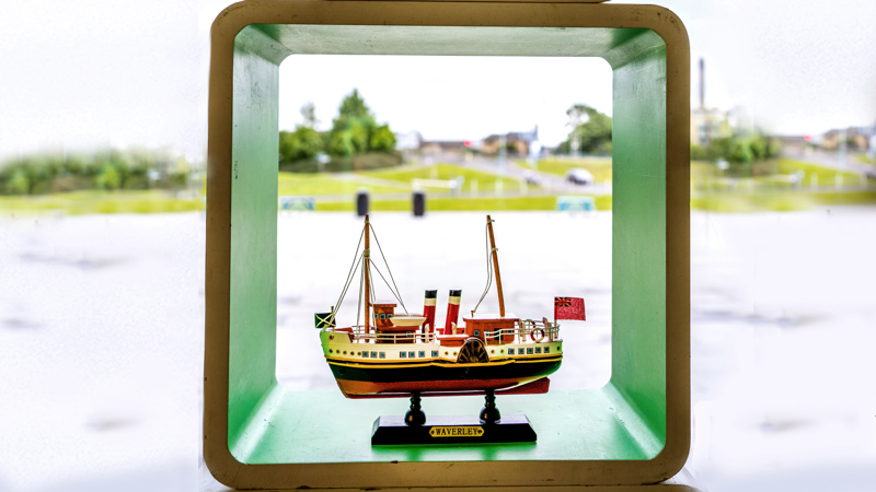 Photograph showing a model of the PS Waverley in front of the River Clyde