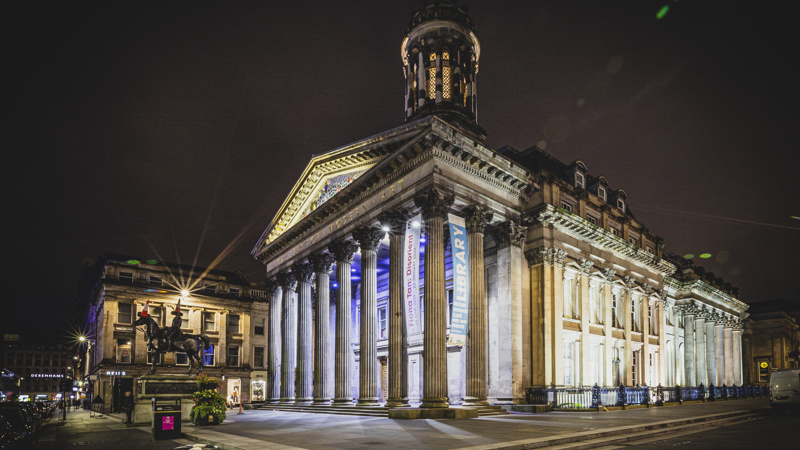 View of the exterior of the Gallery of Modern Art, lit up at night