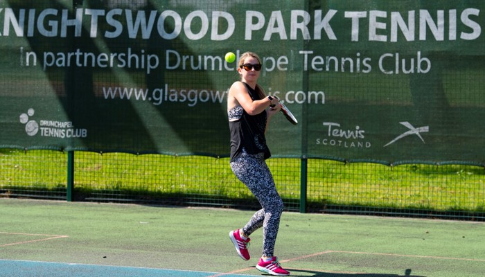 A person playing tennis at Knightswood Park