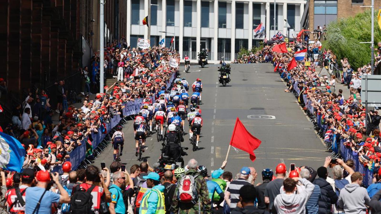 Professional cyclists racing up a hill on Montrose Street in Glasgow