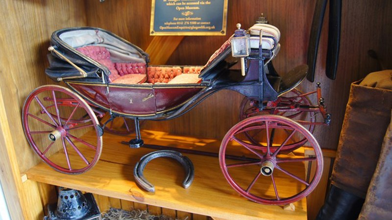 Photograph showing a vintage vehicle on display at Castlemilk Stables