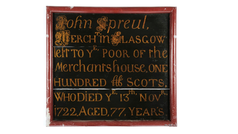 black board with red outline and yellow text describing a gravestone like epitaph to a John Spreul