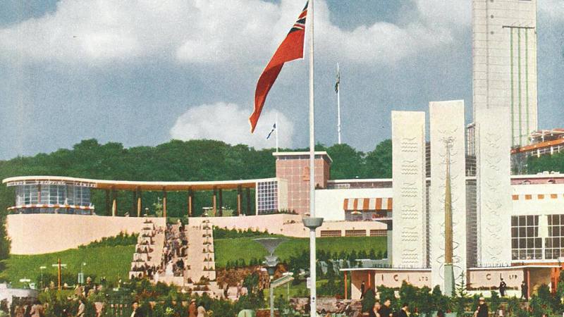 This colour photograph shows a view of the Empire Exhibition from the south, looking up the hill over the South Cascade to the Garden Club and the Tower of Empire.