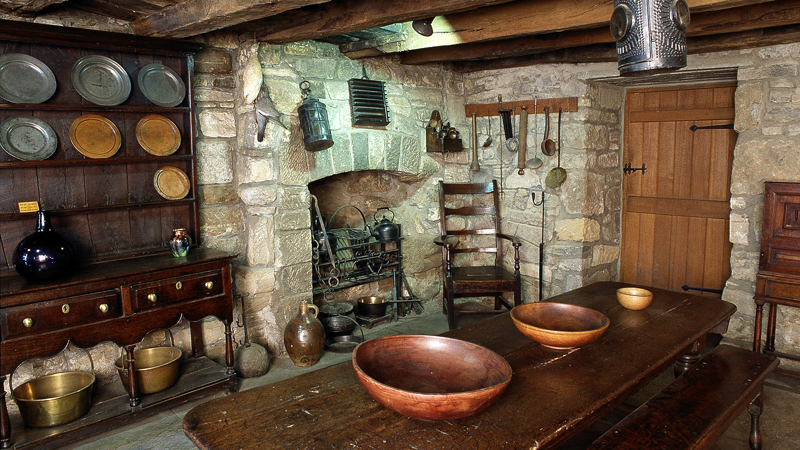 Photograph showing the interior of Provand's Lordship featuring a dining table in stone room.