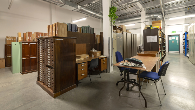 View of one of the storage pods inside GMRC with a large wood filing cabinet in foreground