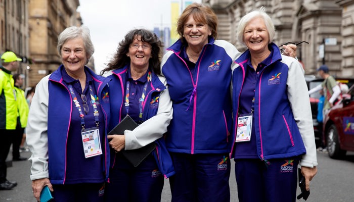 Four adult volunteers of mixed ages during the 2018 European Championships in Glasgow.