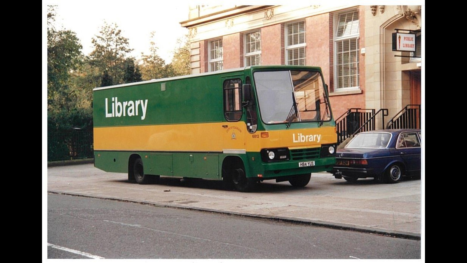 Mobile library bus standing outside a public library.