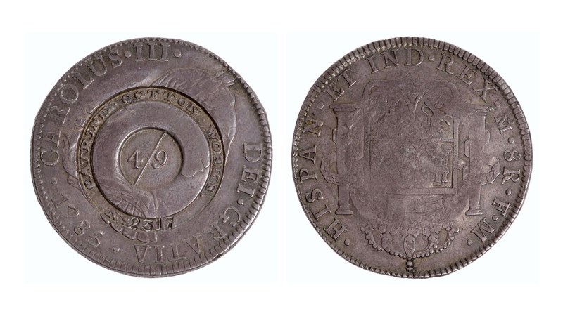 the front and back sides of a coin showing two patterns in bas-relief on the coin faces. one side shows a circular pattern whilst the other shows a coat of arms.