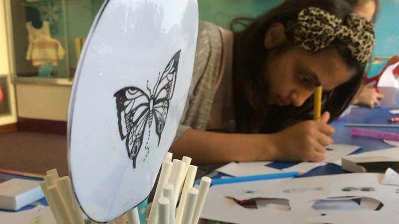 Children at a table colouring in 