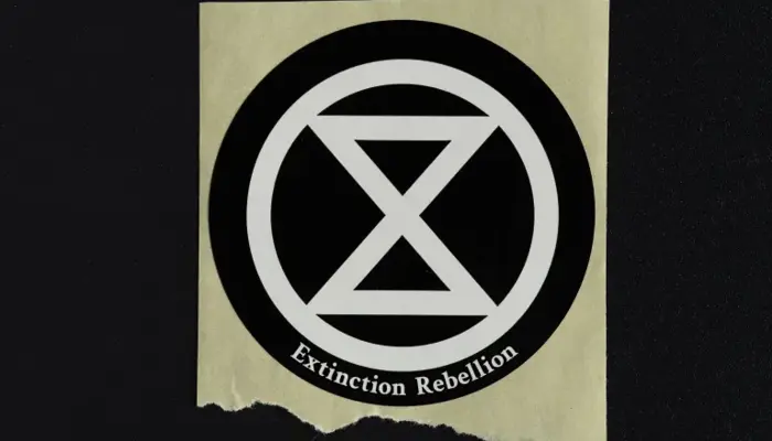 photo of a sticker bearing the logo of Extinction Rebellion