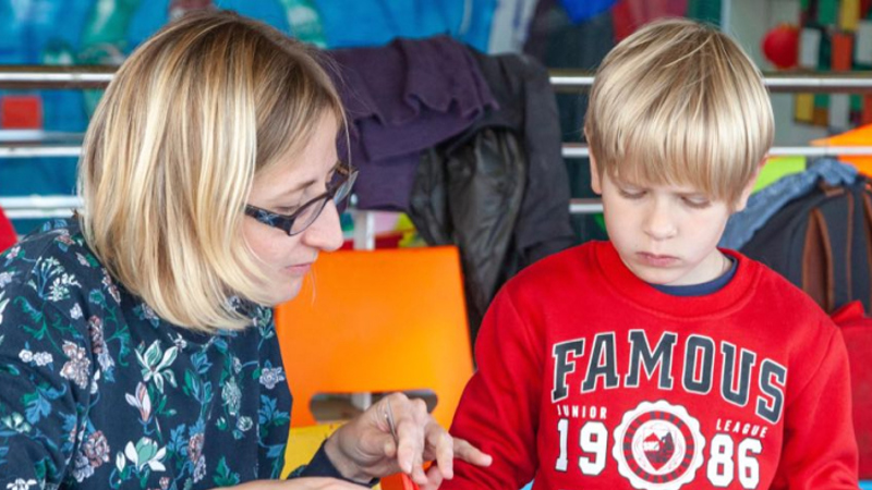 Photograph shows a young family attending a Learning event