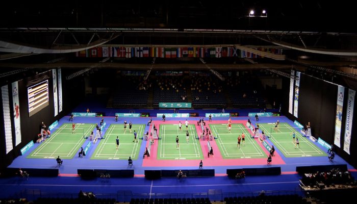 An aerial shot of five badminton courts with competitors playing on the during the Scottish Open Badminton.