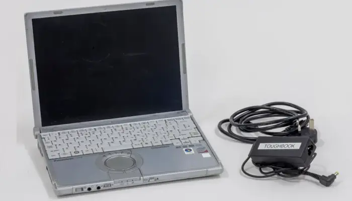 a photograph of a laptop and charger.