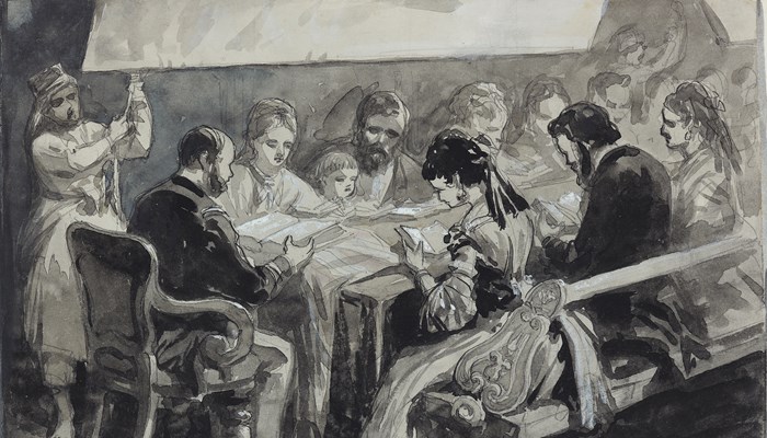 A group of people sit a table