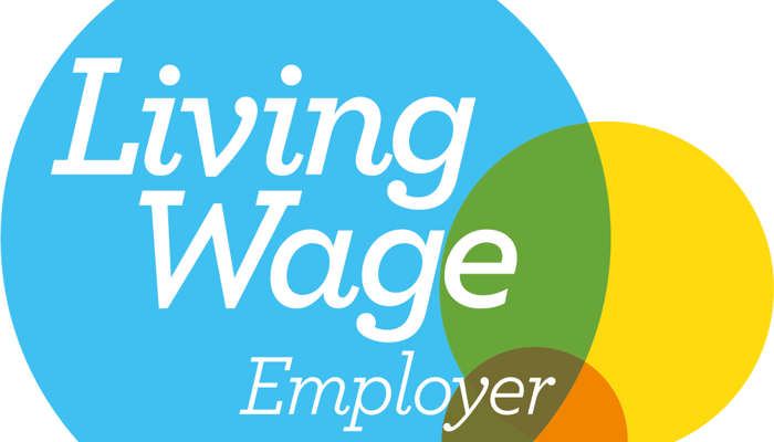 Living Wage Employer logo: A blue circle with the text "Living Wage Employer" and three overlapping coloured circles (green, yellow, and orange), with a green checkmark.