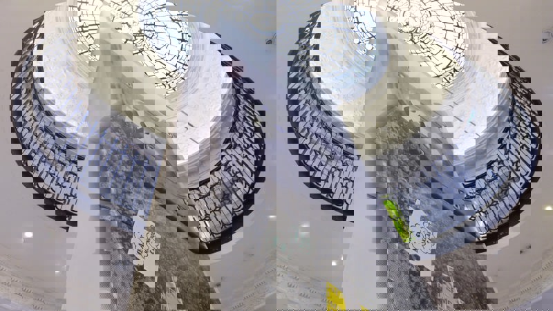 A vast banner, pictured from below, hangs in GoMA's grand main entrance