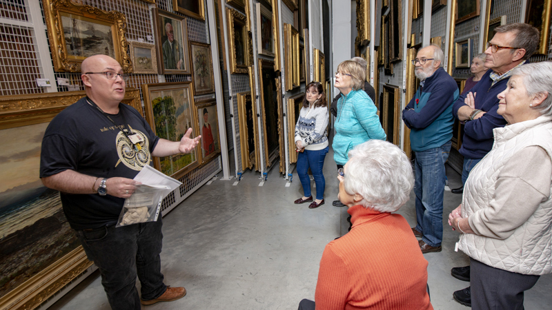 Photograph shows a Behind the Scenes in progress with visitors at GMRC.