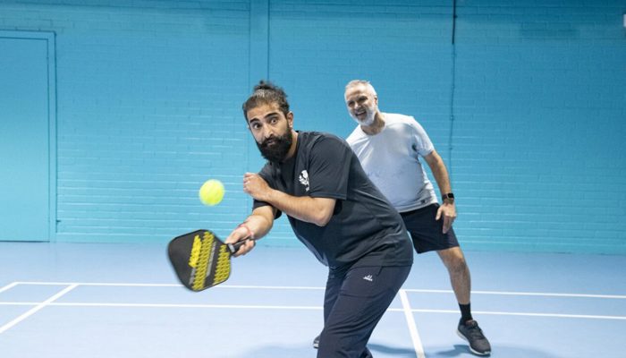 2 people playing Pickleball