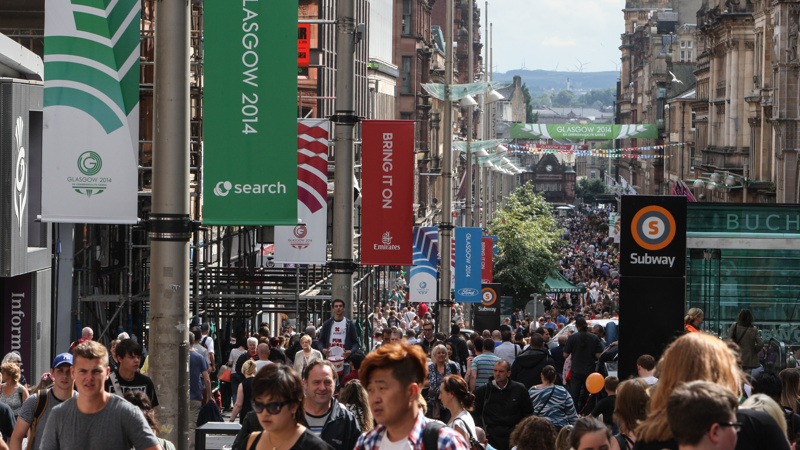 Crowds of people walking on Buchanan Street on a sunny day during the Glasgow 2014 Commonwealth Games.