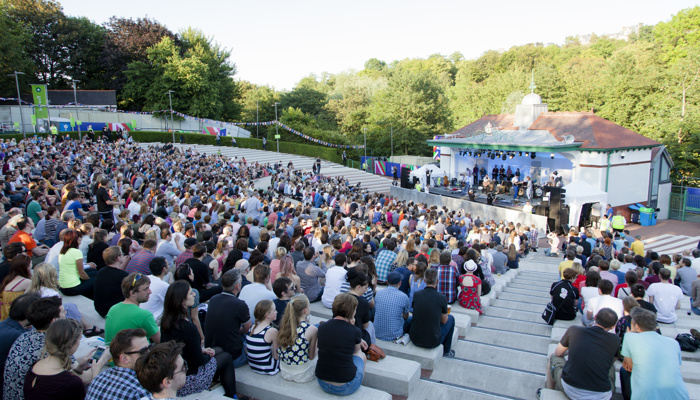 Crowds sitting down watching a performance at the Kelvingrove Bandstand during the Glasgow 2014 Commonwealth Games.