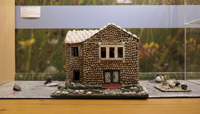 Small model of a house made of shells