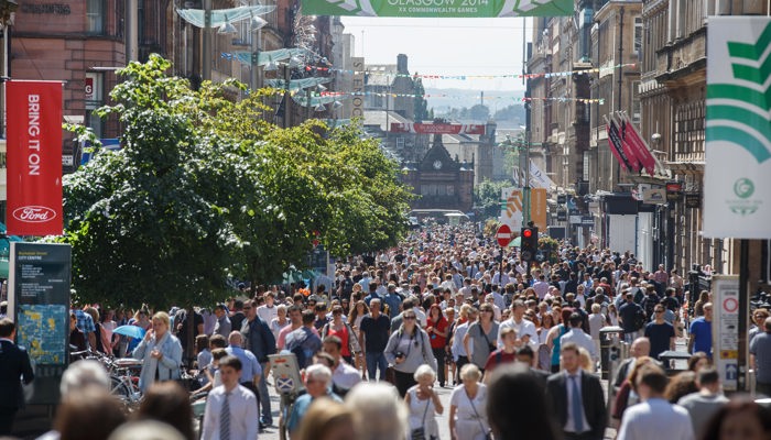 Large crowds of people walking down Buchanan Street on a sunny day during the Glasgow 2014 Commonwealth Games.