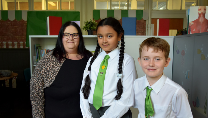 Photograph showing Glasgow Life Learning and Access Curator Caroline Currie with two pupils from St Convols