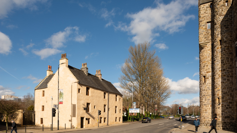 exterior of Provand's Lordship a medieval building on a street opposite St Mungo Museum of Religious Life and Art blue sky behind