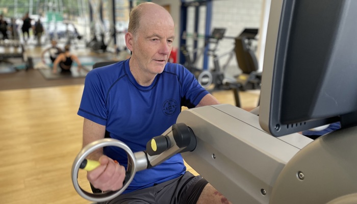 Glasgow Club member Raymond Ward using a hand bike machine at Glasgow Club Tollcross gym.