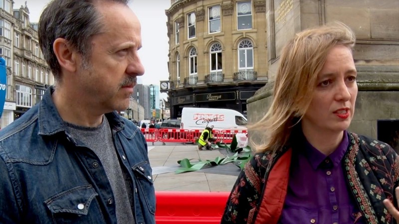 Artists Neil Bromwich and Zoe Walker pictured on a city street