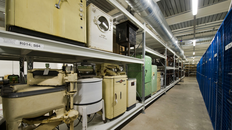 Photograph shows a collection of vintage washing machines and fridges stored at GMRC.